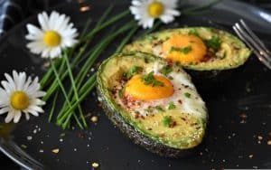 alkaline breakfast with eggs on sliced avocados