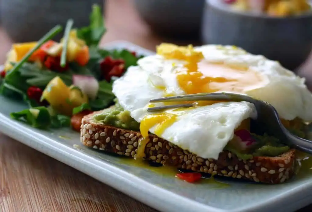 eggs over easy over whole grain toast and salad